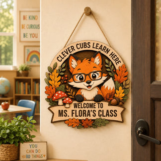 A wooden classroom sign for Ms. Flora featuring a cute fox wearing glasses with fall foliage for teacher appreciation.