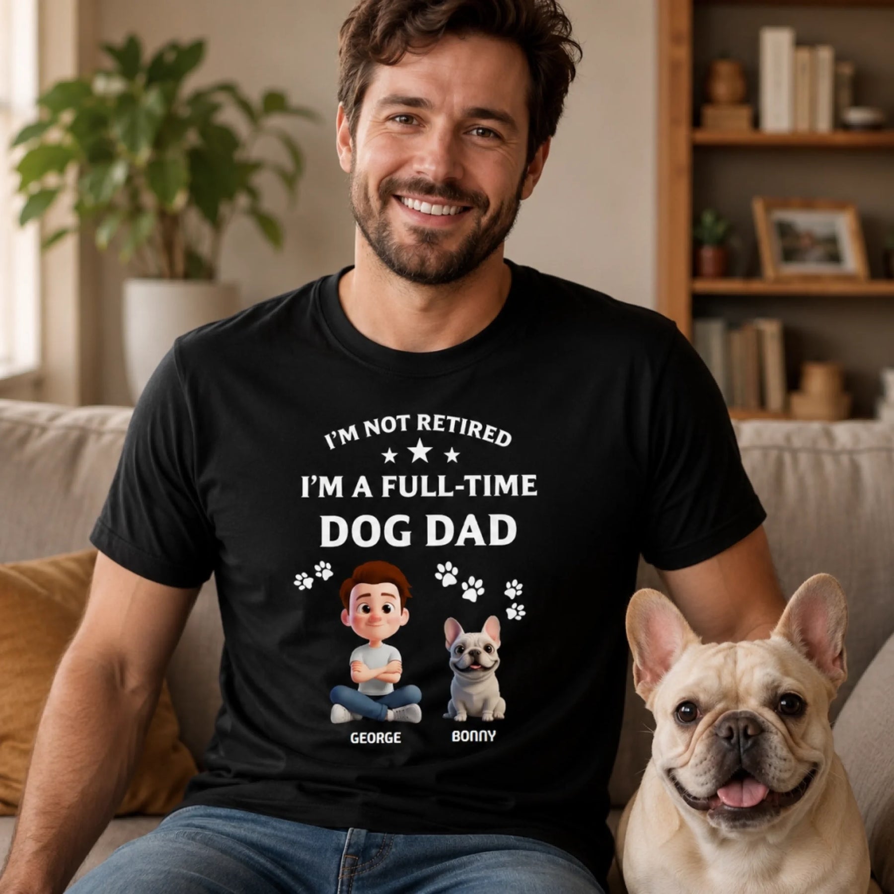 Man wearing a black t-shirt with a dog-themed design, sitting next to a dog in a living room.
