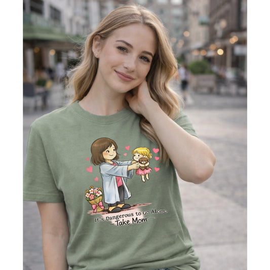 Woman wearing a green t-shirt with a graphic design and text, standing on a street.