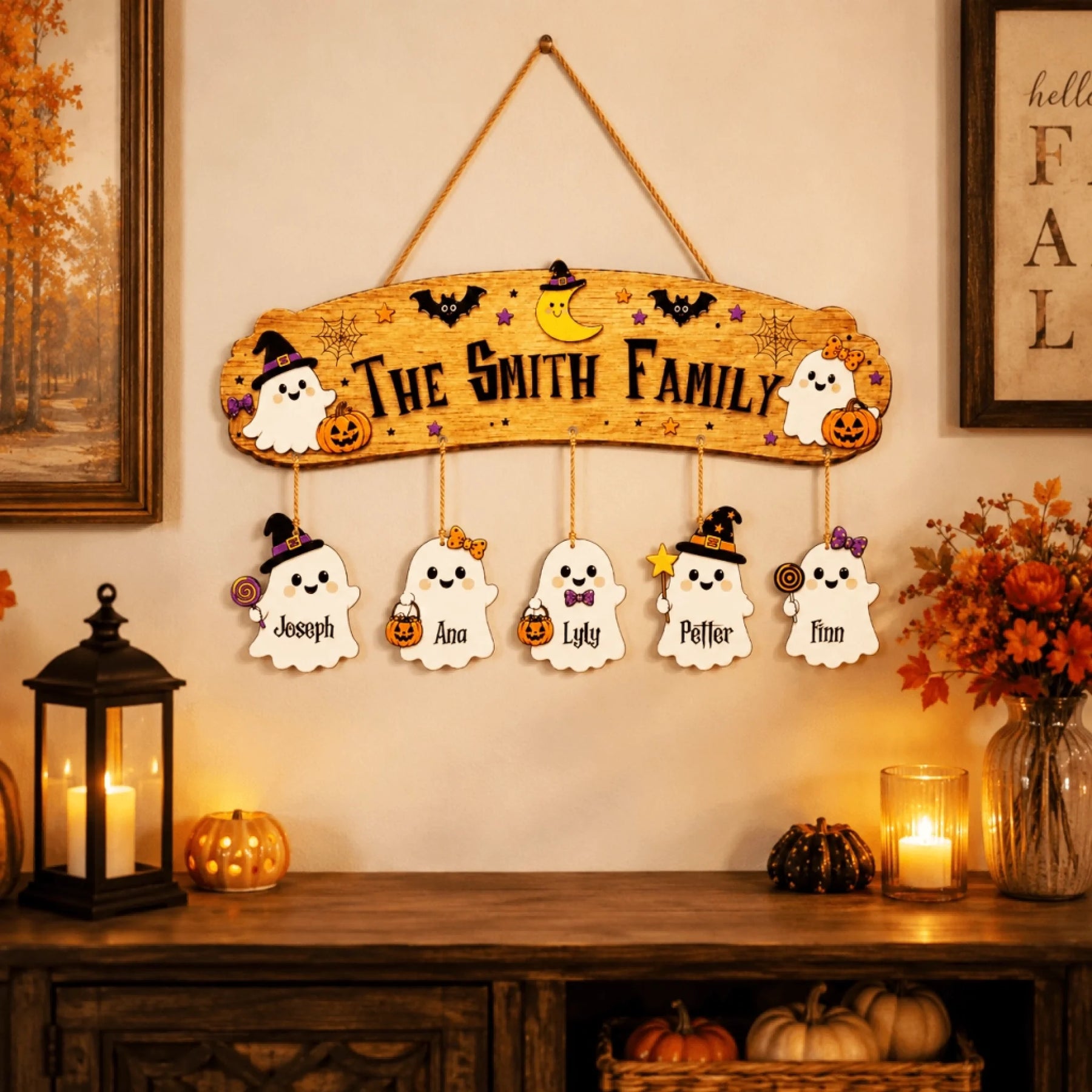 Halloween themed wooden wall sign personalized with a ghost family design and individual hanging name plaques for seasonal decor.