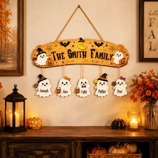 Halloween themed wooden wall sign personalized with a ghost family design and individual hanging name plaques for seasonal decor.