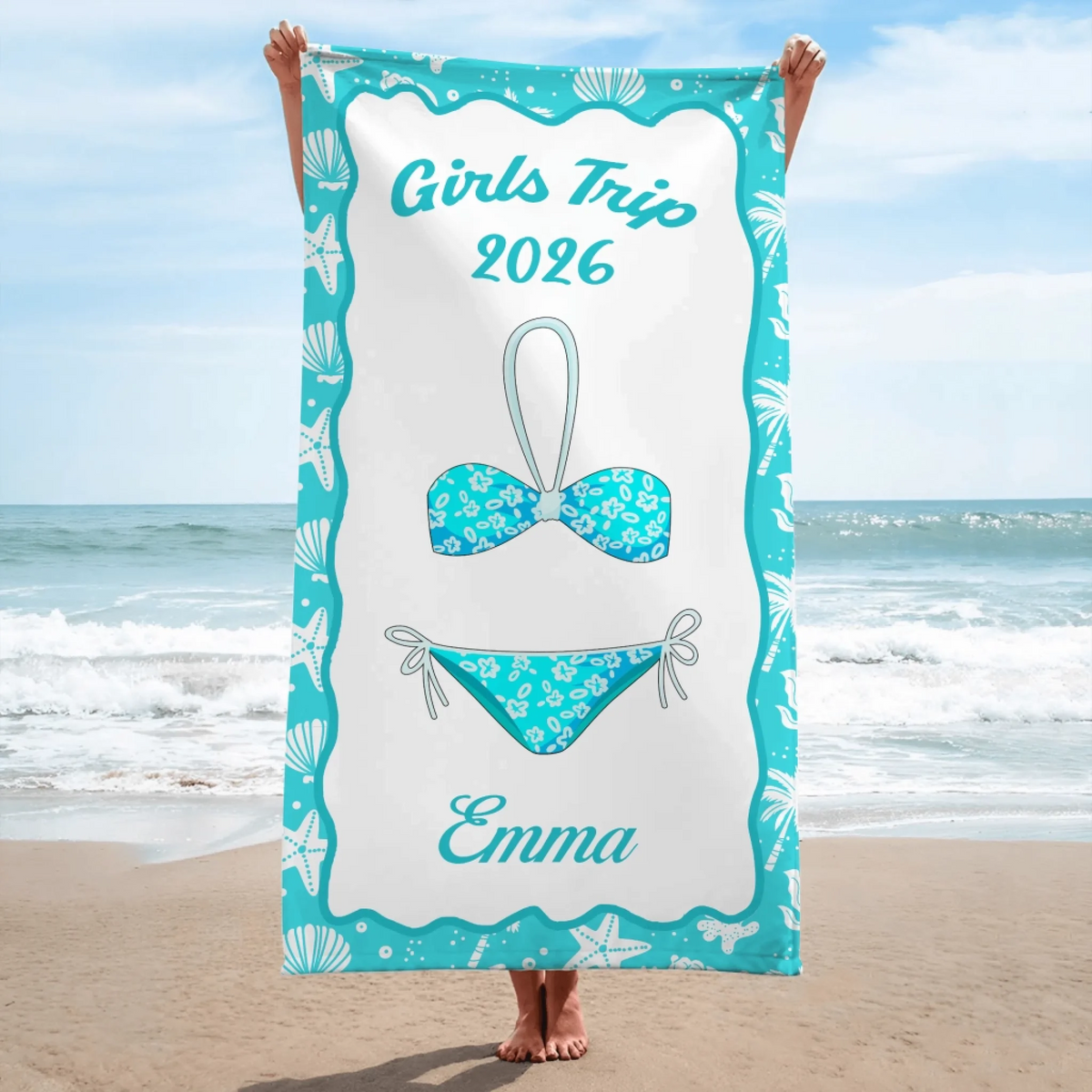 A personalized beach towel for a 2026 girls trip featuring a bikini design and the name Emma in a teal coastal frame.