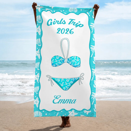 A personalized beach towel for a 2026 girls trip featuring a bikini design and the name Emma in a teal coastal frame.