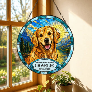 A round personalized golden retriever memorial suncatcher with Charlie name and dates, displayed hanging in a window.