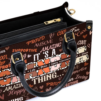 Close up of a custom Grandma handbag featuring leopard print lettering and family names on a brown leather surface.
