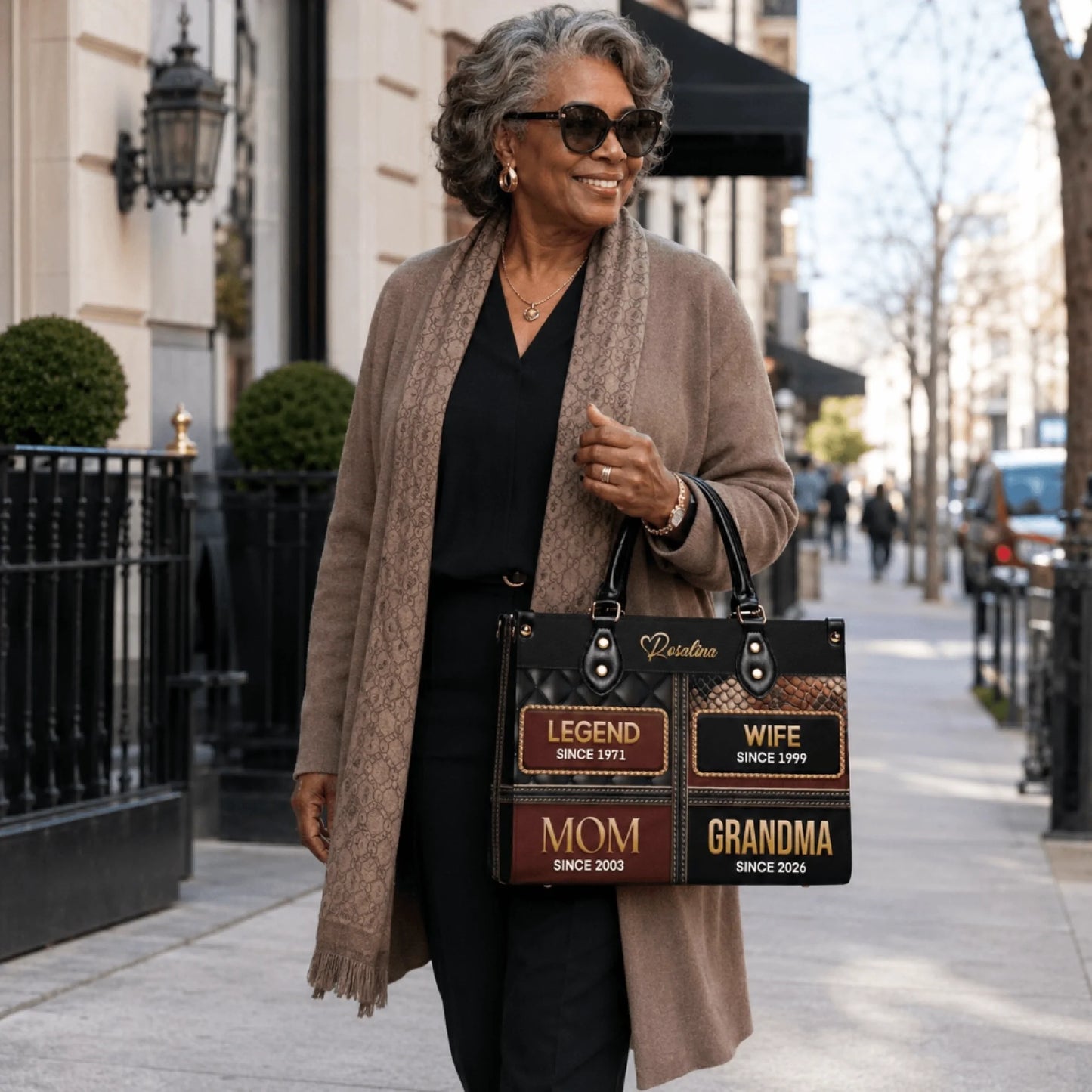 Stylish woman carrying a personalized grandma handbag featuring milestone years, an ideal sentimental Mother Day gift idea.