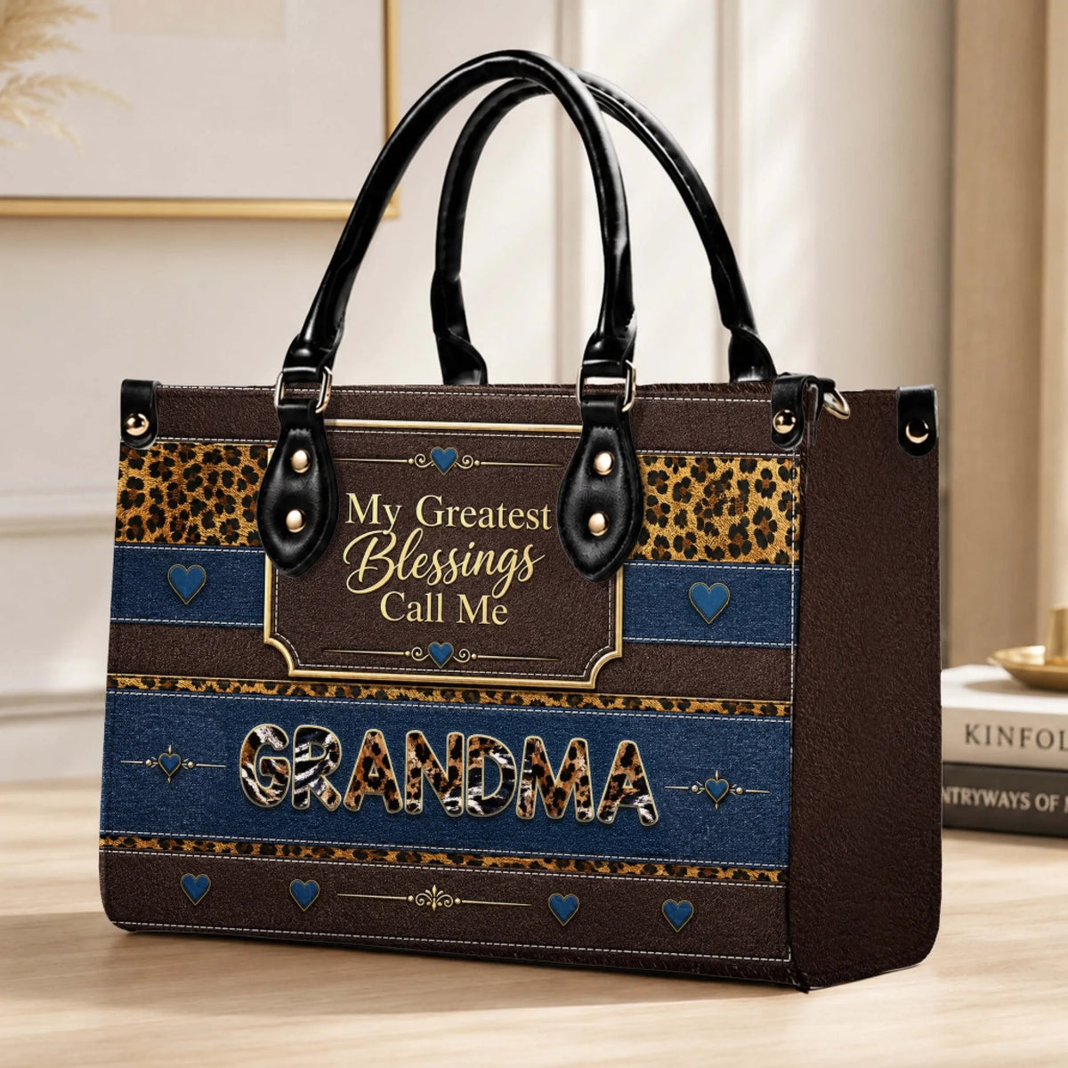 Stylish leopard and blue stripe tote bag with the custom text My Greatest Blessings Call Me Grandma on a table.