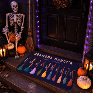 Custom Grandma Nancys little wizard Halloween doormat displayed on a porch with a skeleton, pumpkins, and personalized family broomsticks.