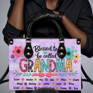 Woman holding a personalized Blessed to be called Grandma floral tote bag customized with various family names.