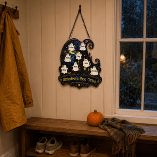 A personalized Halloween ghost wall decor sign labeled Grandma's Boo Crew hanging in a rustic entryway.