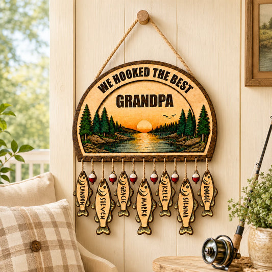 Custom wooden fishing sign for grandpa featuring a sunset lake scene and hanging fish plaques with names for each grandchild.