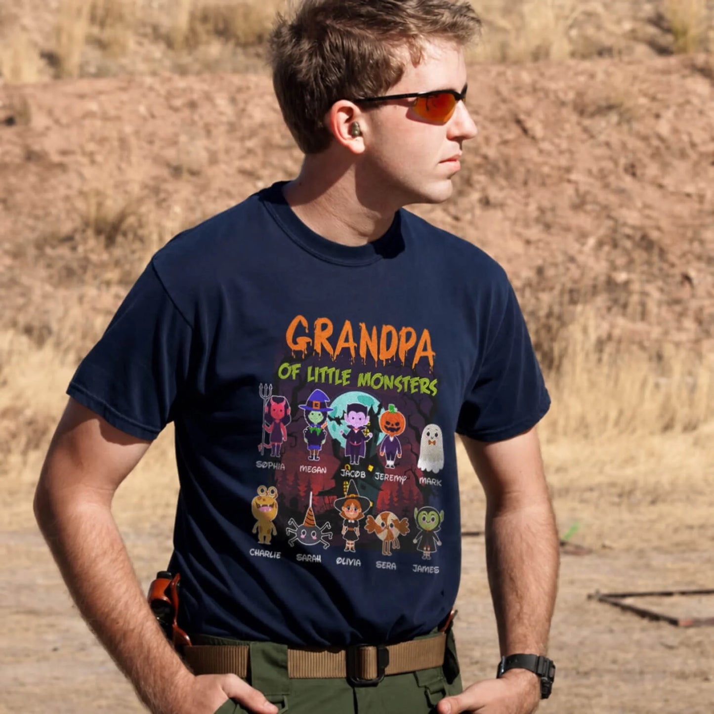 A navy blue personalized Halloween T-shirt for grandpa, displaying 10 different spooky monster characters with names.