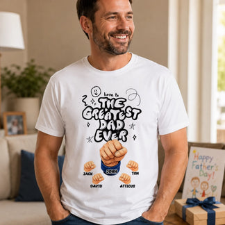 Man wearing a white t-shirt with 'The Greatest Dad Ever' design in a living room.