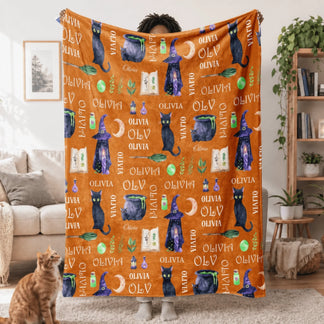 Custom name Olivia Halloween fleece blanket with witch hat black cat and potion motifs in vibrant orange and black.