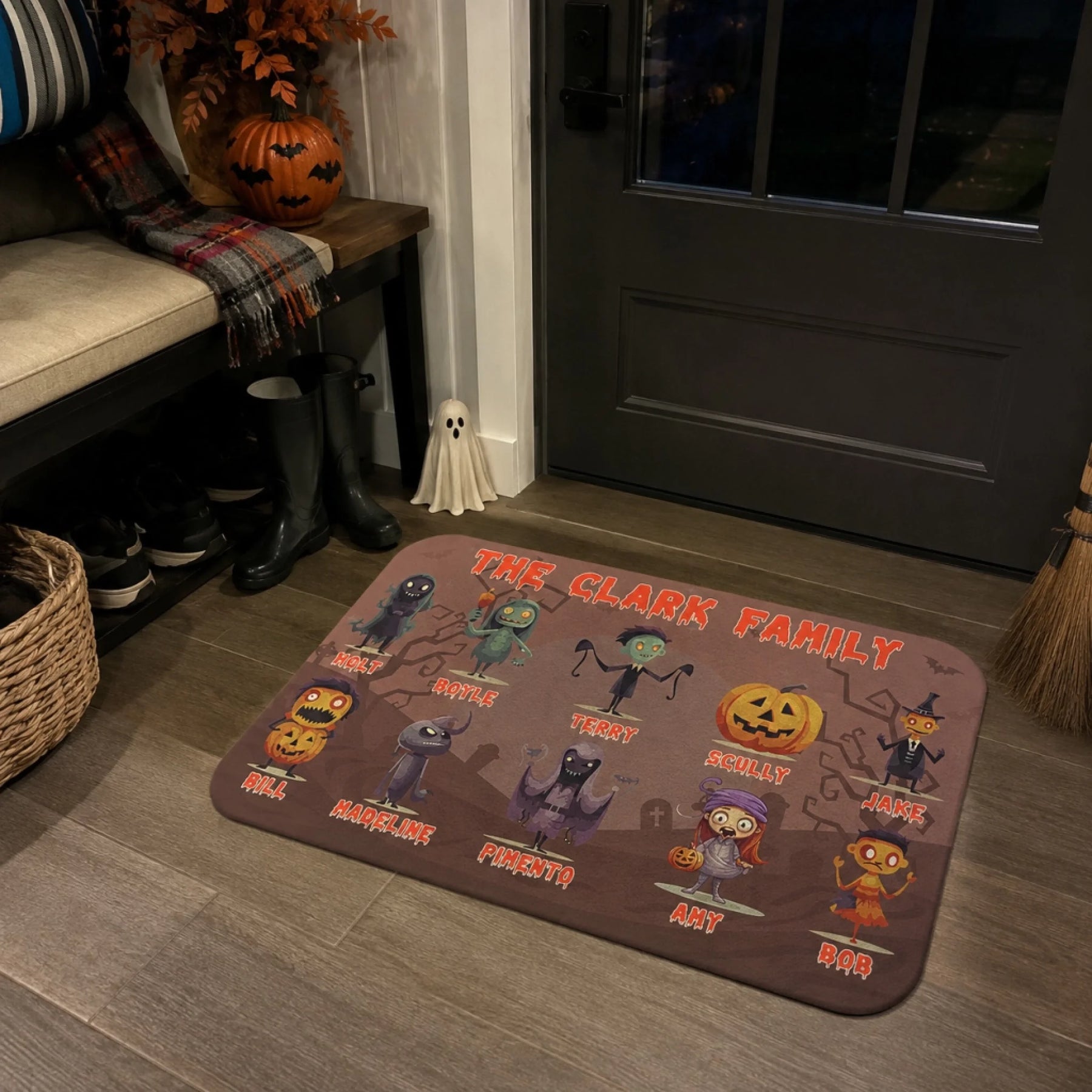 A personalized Halloween doormat featuring spooky cartoon characters and custom names for The Clark Family house decor.