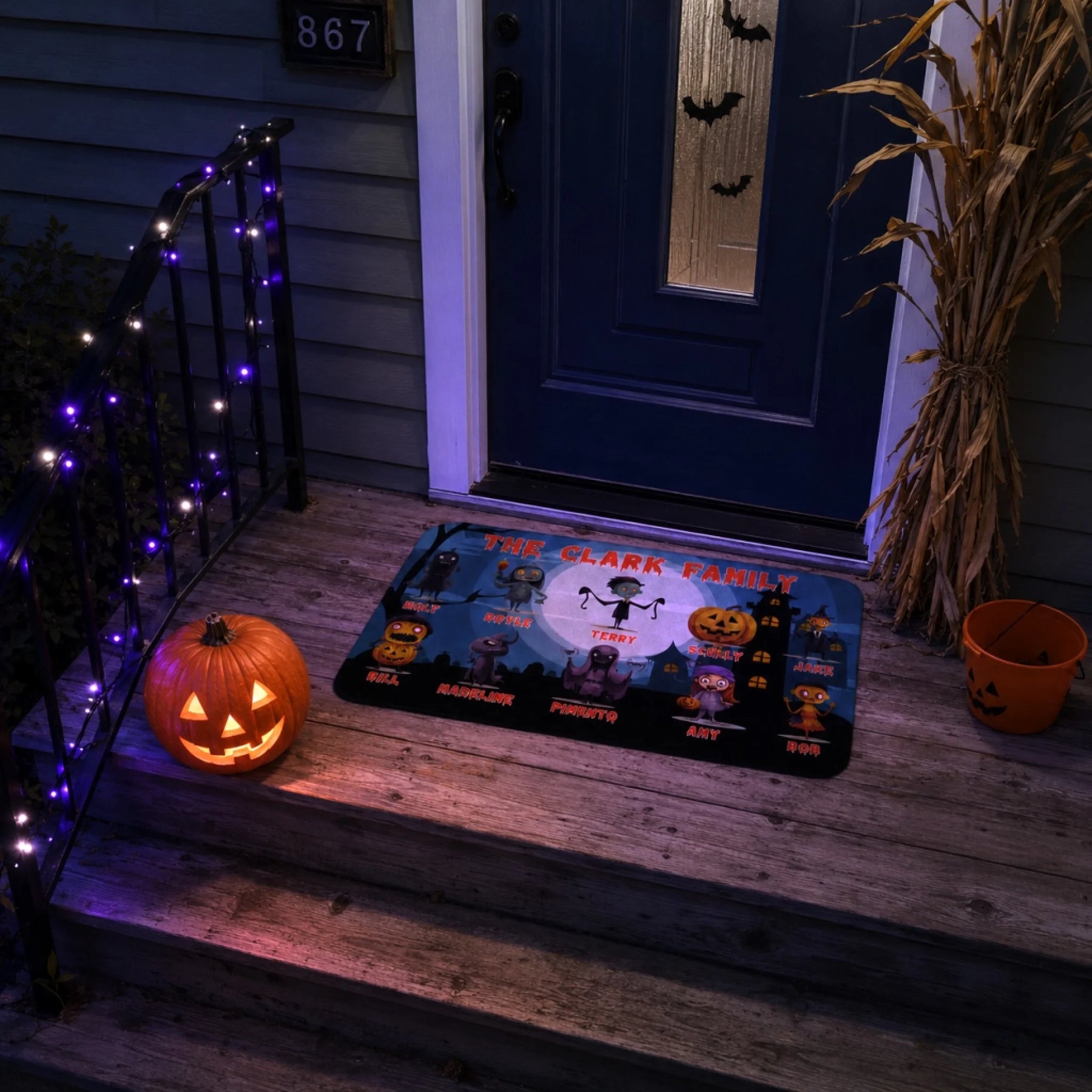Customized Halloween floor mat featuring cute scary monsters and printed family names for festive porch decor.