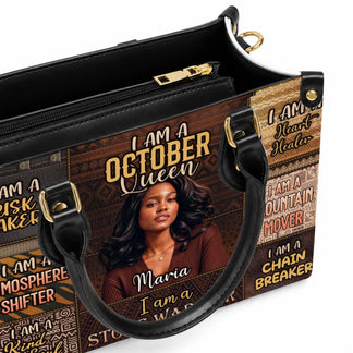 Detail view of a personalized handbag featuring the custom text I Am An October Queen and a woman's portrait.