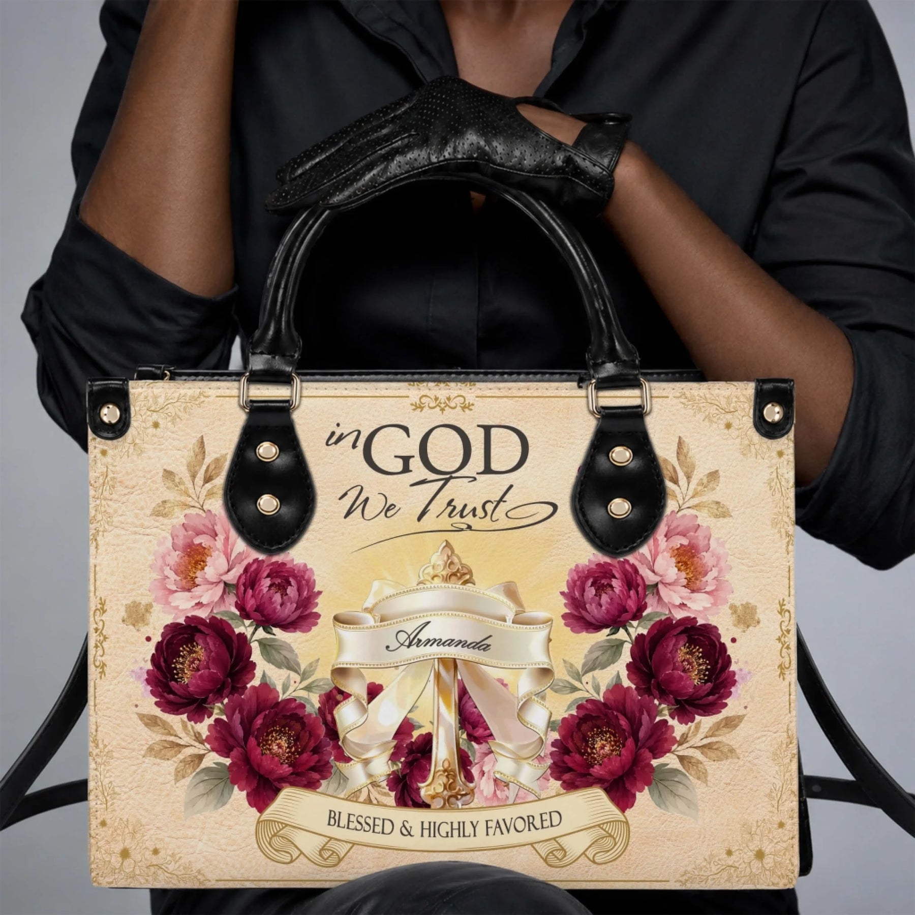 A stylish personalized PU leather handbag featuring floral designs and the inspirational religious quote In God We Trust.