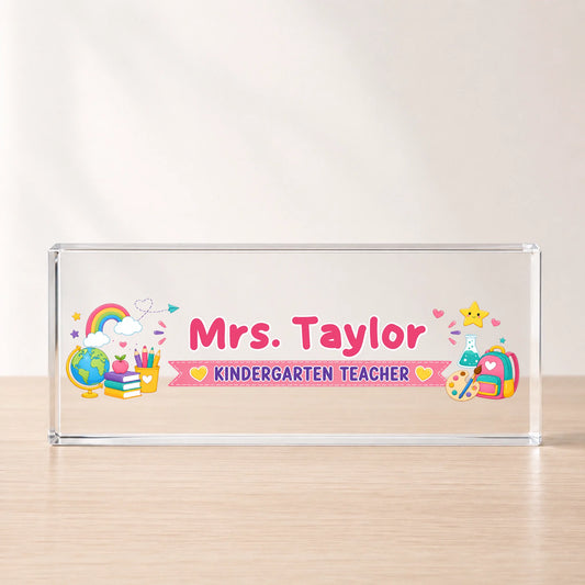 Custom acrylic desk plaque for a kindergarten teacher featuring cute school icons and Mrs Taylor name personalization.