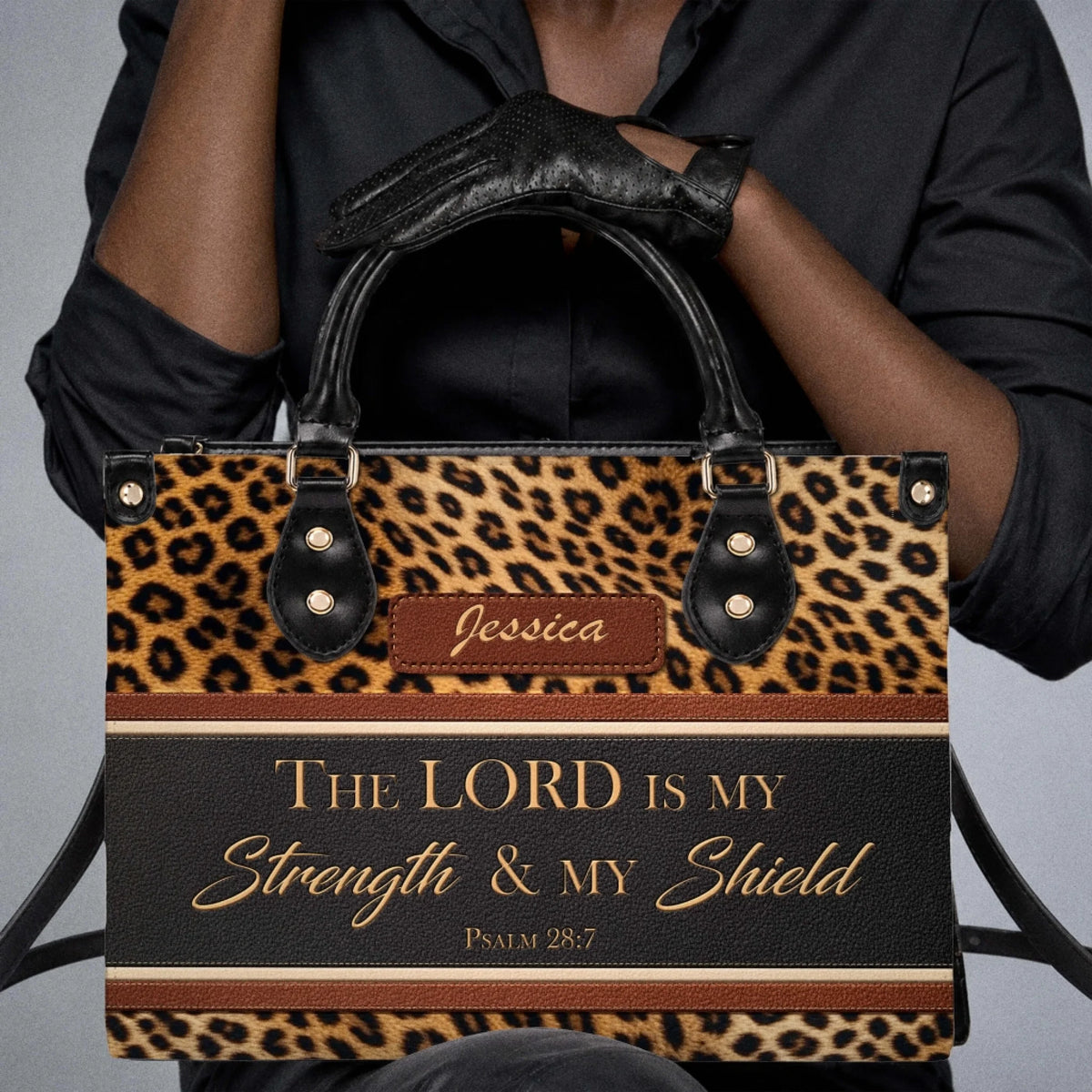 Close up of a personalized leopard print tote bag with The Lord Is My Strength and My Shield bible verse design.