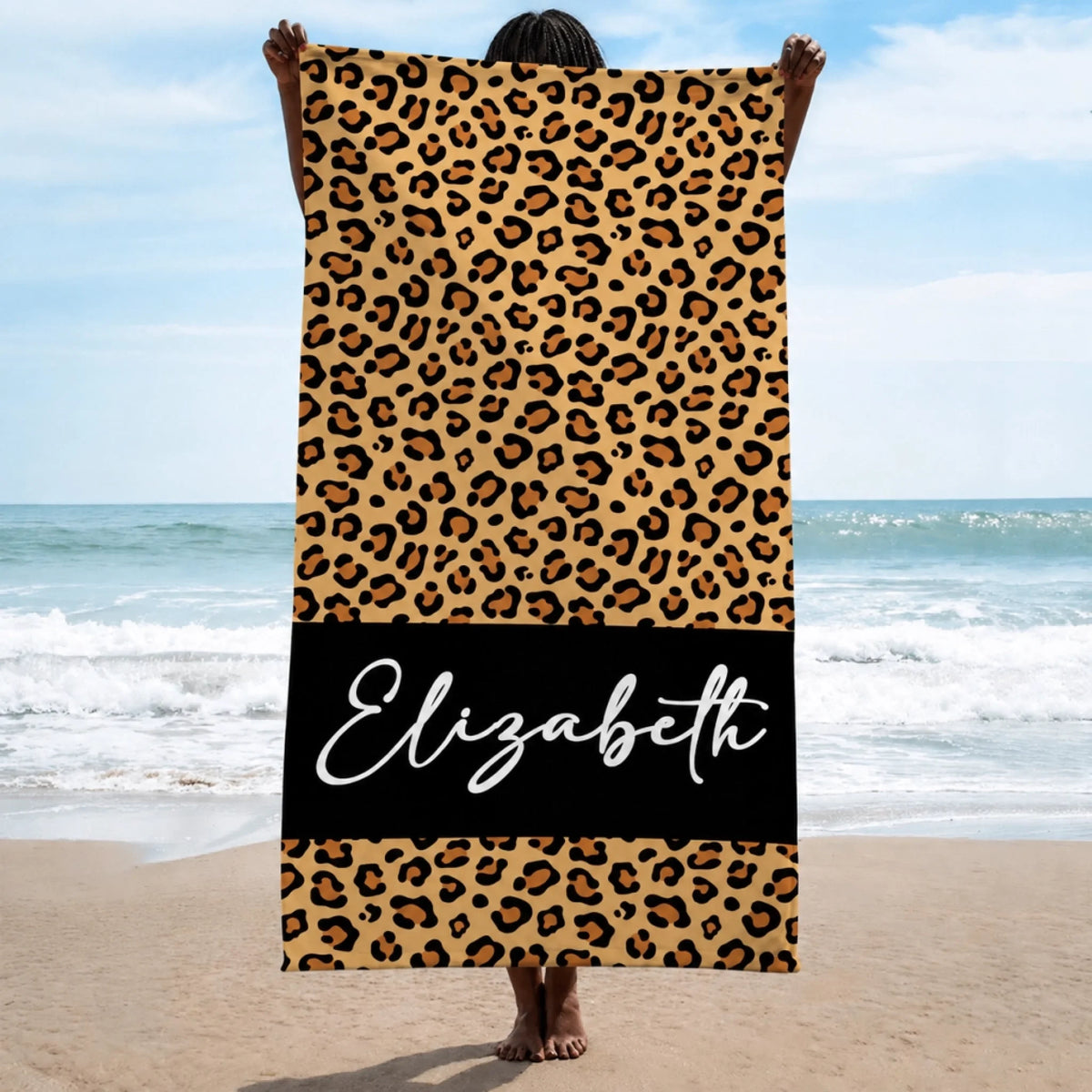 Custom leopard print beach towel featuring the name Elizabeth on a black band, perfect for summer pool or beach days.