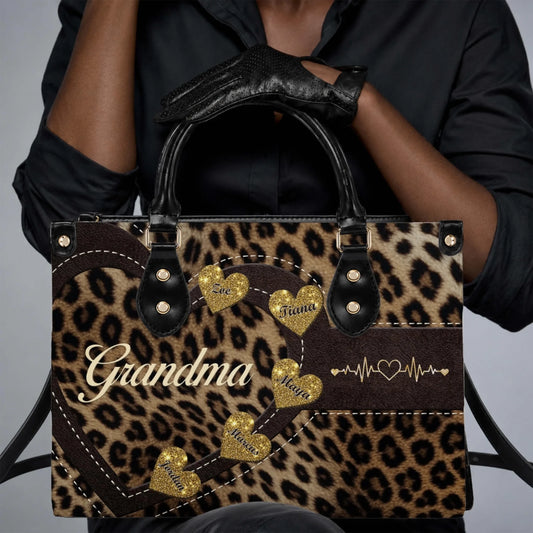 Personalized leopard print handbag for grandma featuring custom names on gold glitter hearts and a heart heartbeat design.