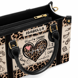Close up interior view of a stylish leopard print nurse tote bag showing the gold zipper and personalized design detailing.