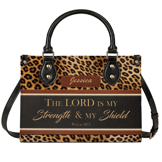 A stylish personalized leopard print handbag featuring the Bible verse The Lord is my strength and my shield for women.