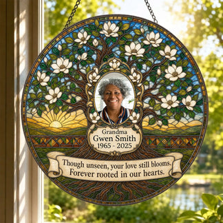 Beautiful magnolia tree memorial suncatcher hanging in a window with custom Grandma photo and remembrance dates.
