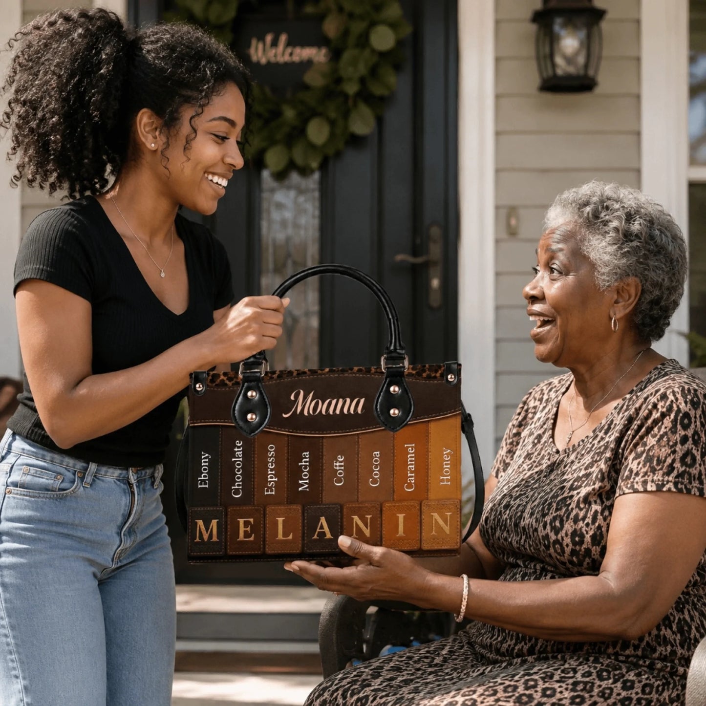 Young woman gifting a personalized Moana handbag featuring a melanin skin tone gradient design to an elderly woman.