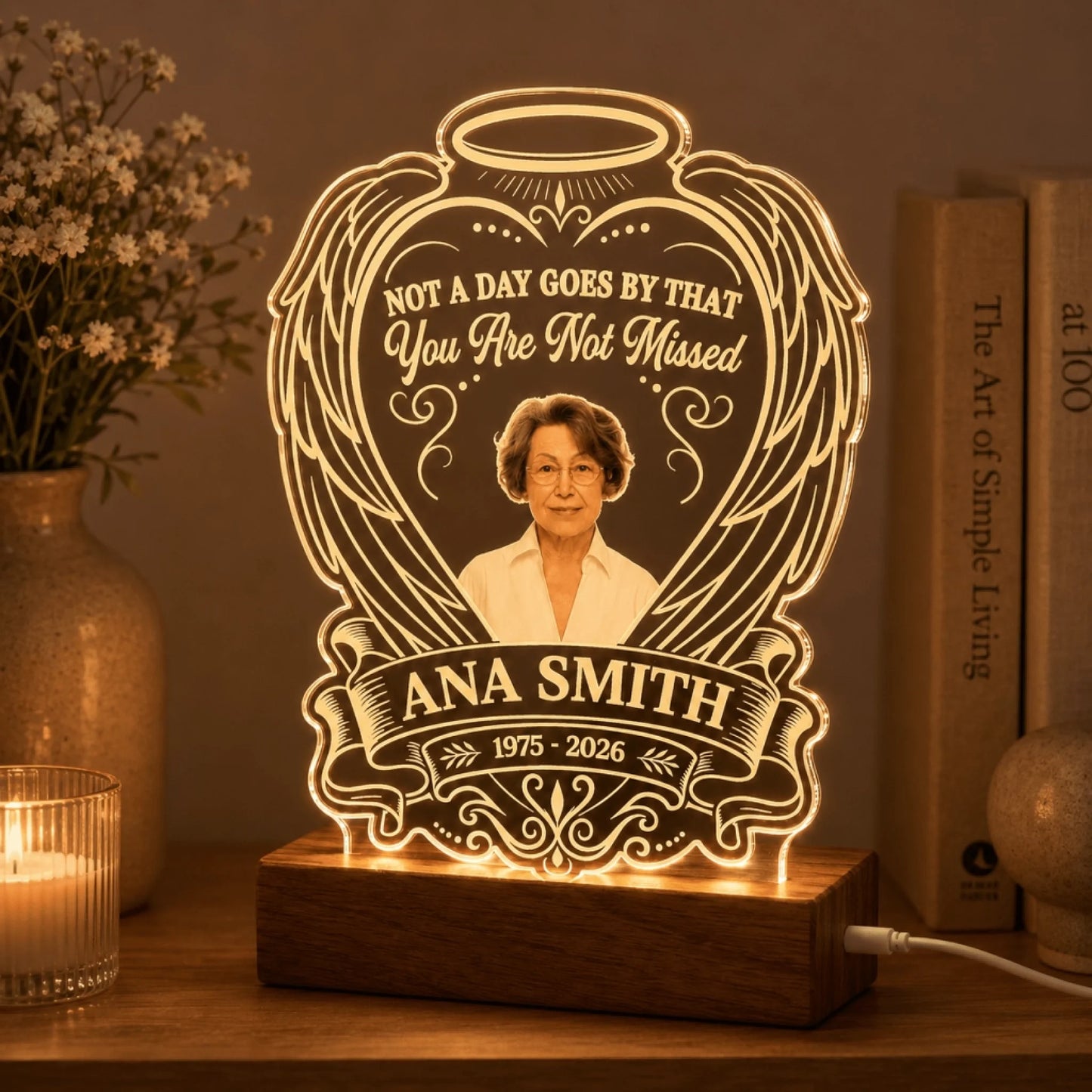 Custom memorial LED night light with portrait, angel wings design, and Ana Smith text, glowing on a wooden base.