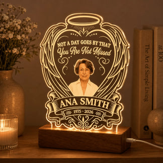 Custom memorial LED night light with portrait, angel wings design, and Ana Smith text, glowing on a wooden base.