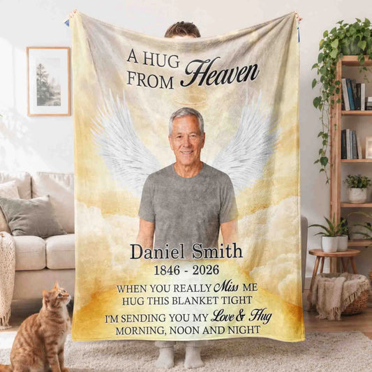Custom memorial fleece blanket featuring a photo of a loved one with angel wings and the quote A Hug From Heaven.