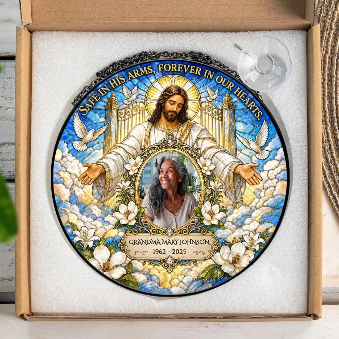 Personalized memorial suncatcher featuring a portrait of a loved one, Jesus, and custom dates in a gift box.