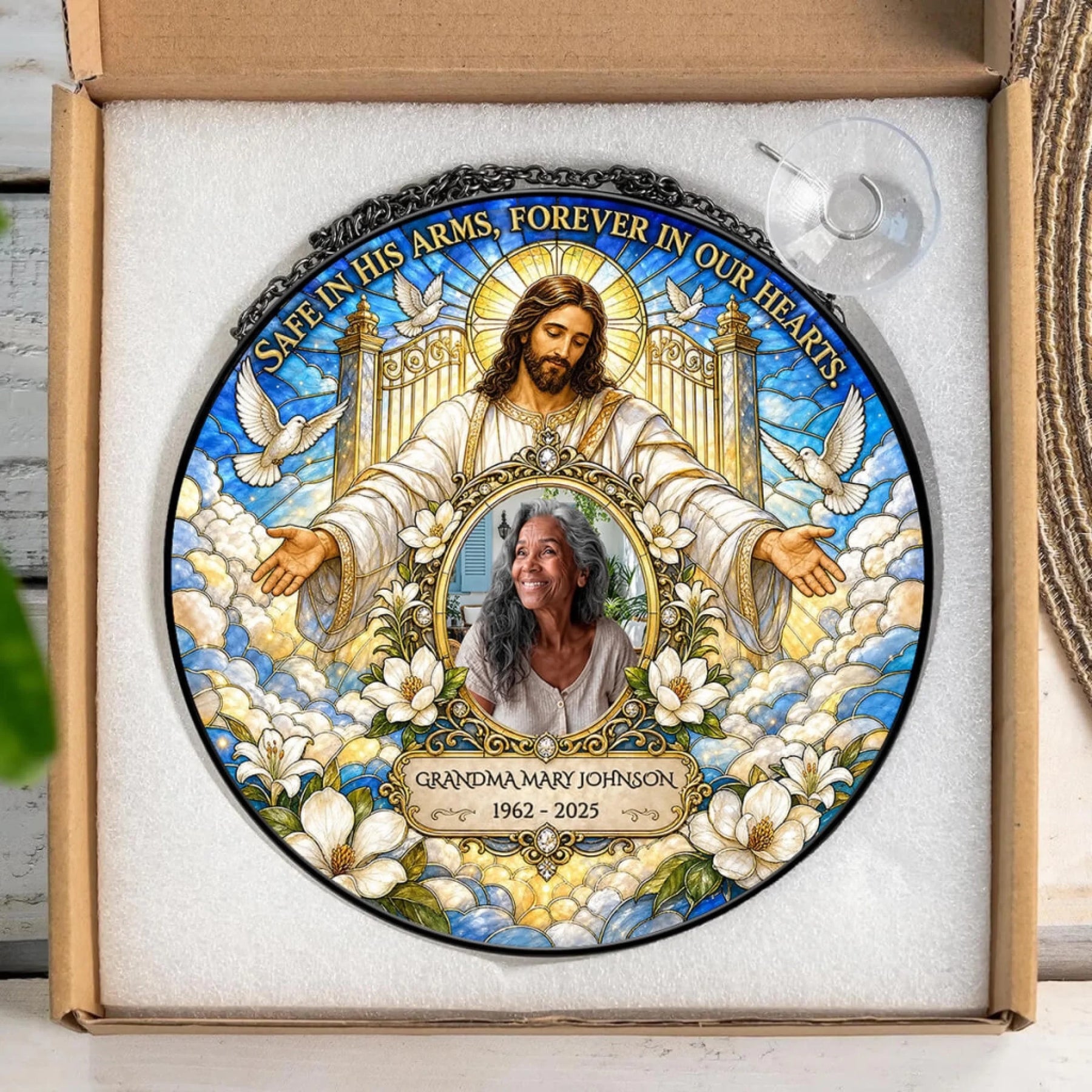 Personalized memorial suncatcher featuring a portrait of a loved one, Jesus, and custom dates in a gift box.