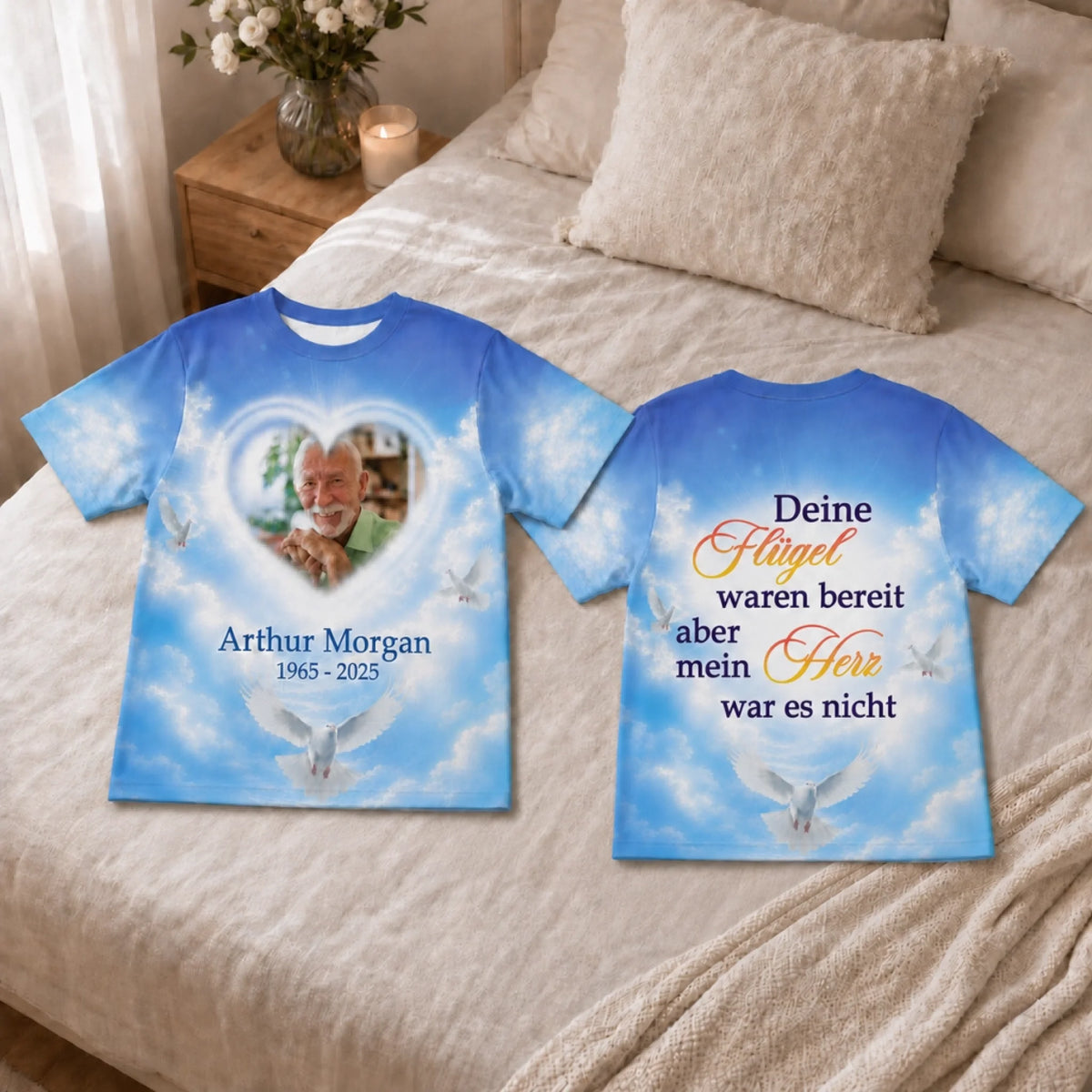 Custom memorial T-shirt with a photo of a loved one in a heart frame and dove imagery on a soft blue sky background.
