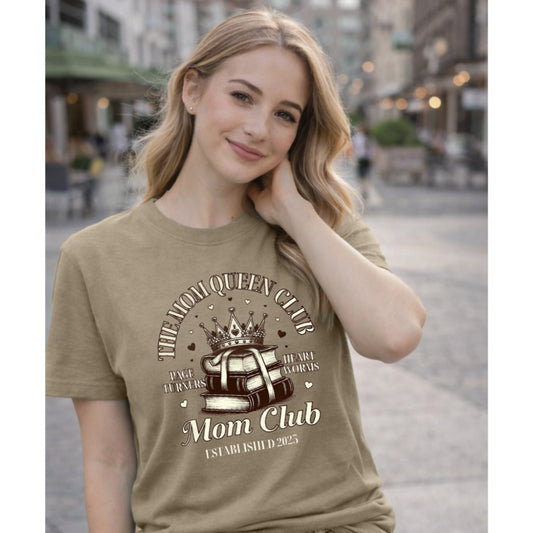 Woman wearing a brown t-shirt with 'Mom Club' design in an urban setting