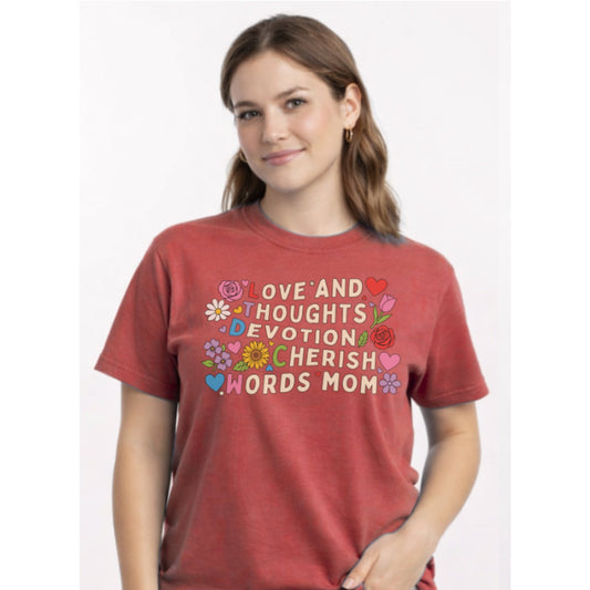 Woman wearing a red t-shirt with colorful text and graphics on a white background