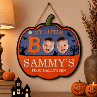 Custom pumpkin shaped wooden hanging sign for baby's first Halloween with Sammy name and two baby face photos included.