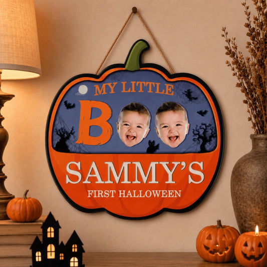Custom pumpkin shaped wooden hanging sign for baby's first Halloween with Sammy name and two baby face photos included.
