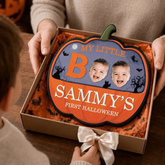 Custom baby first Halloween pumpkin wall decor for Sammy, shown inside a gift box as a personalized holiday present.