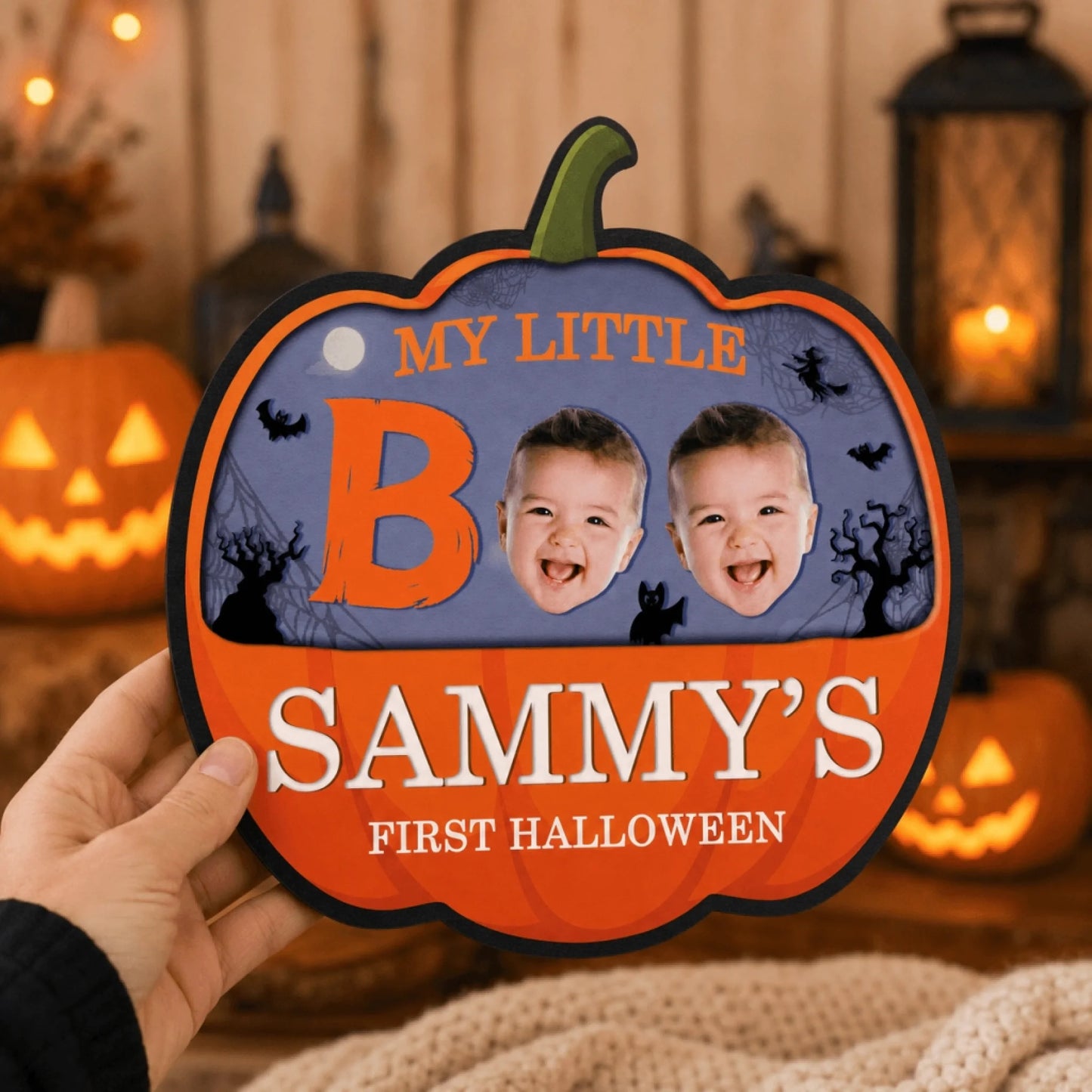 Handheld pumpkin shaped plaque for baby first Halloween, featuring Sammy name and two custom baby face photo inserts.