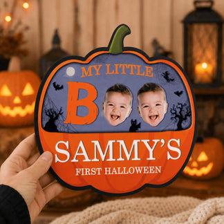 Handheld pumpkin shaped plaque for baby first Halloween, featuring Sammy name and two custom baby face photo inserts.
