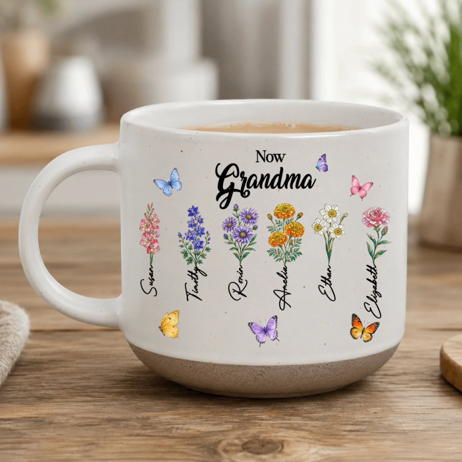 Custom white coffee mug with 'Now Grandma' inscription, illustrated birth flowers, and grandchildren's names.