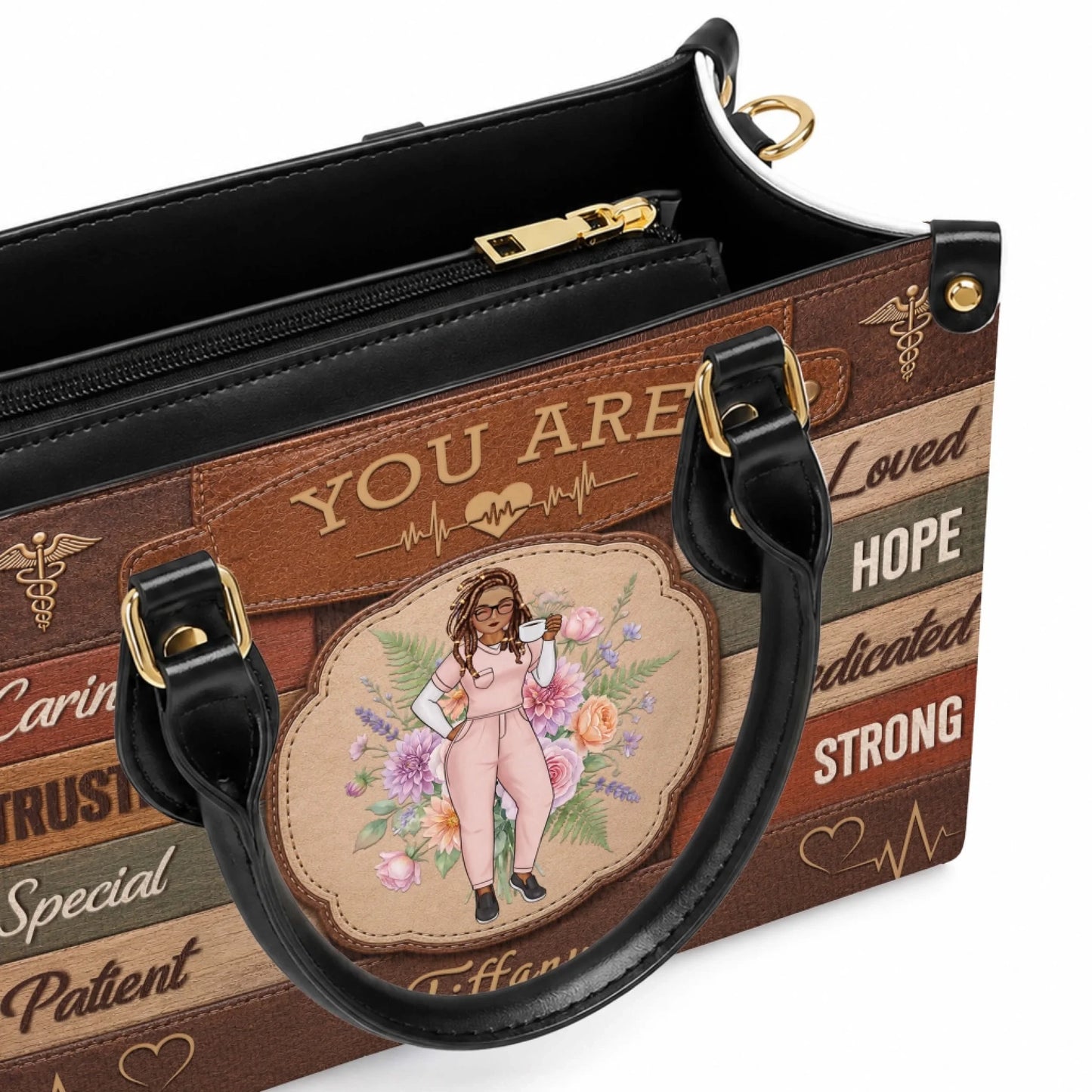 Close up detail of a custom nurse handbag showing a character illustration and inspirational text on a wooden board.