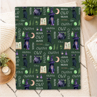 Custom dark green throw blanket with personalized Olivia name witchy icons like cats cauldrons and magic potions.