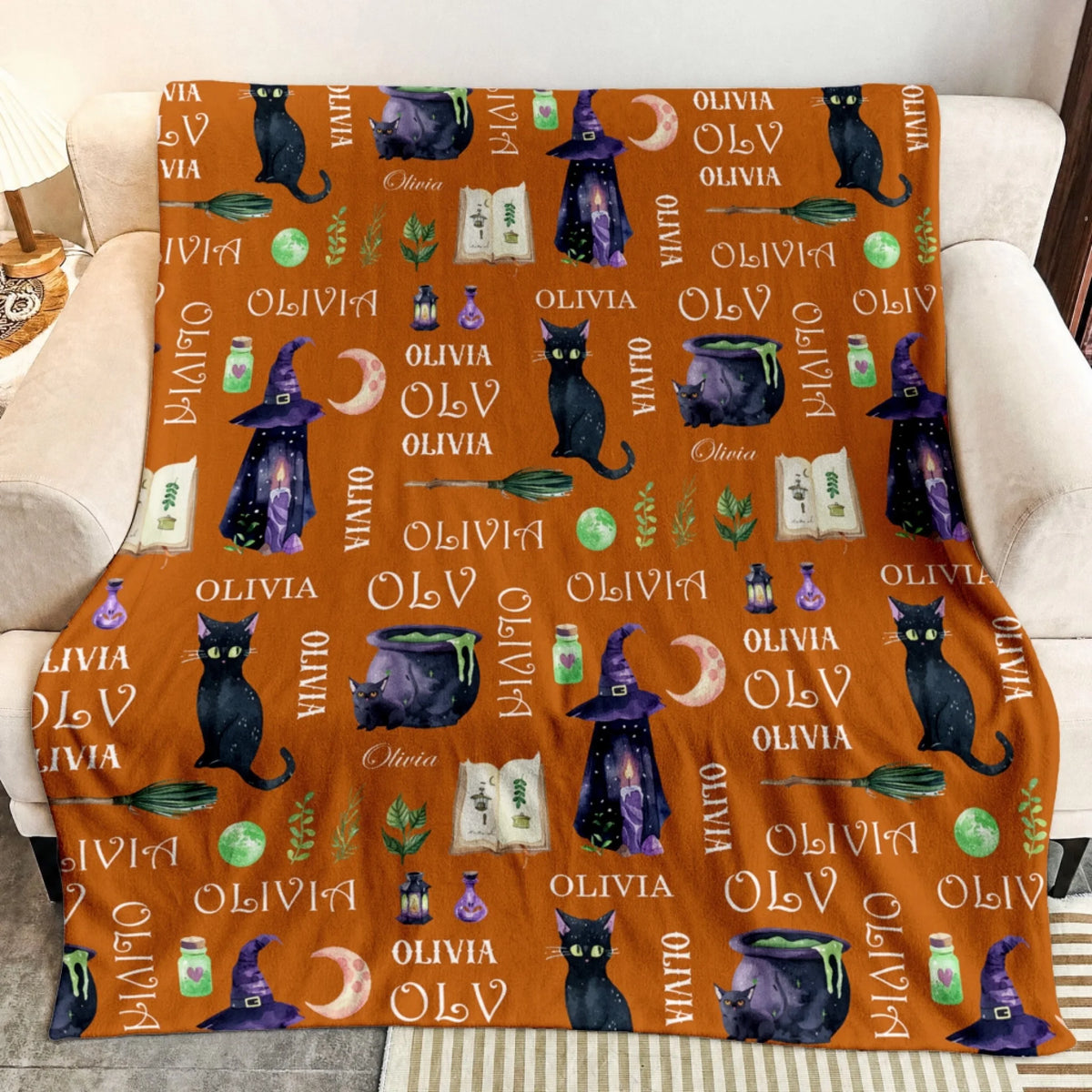 Soft orange personalized blanket featuring mystical witch elements and black cat art customized with the name Olivia.