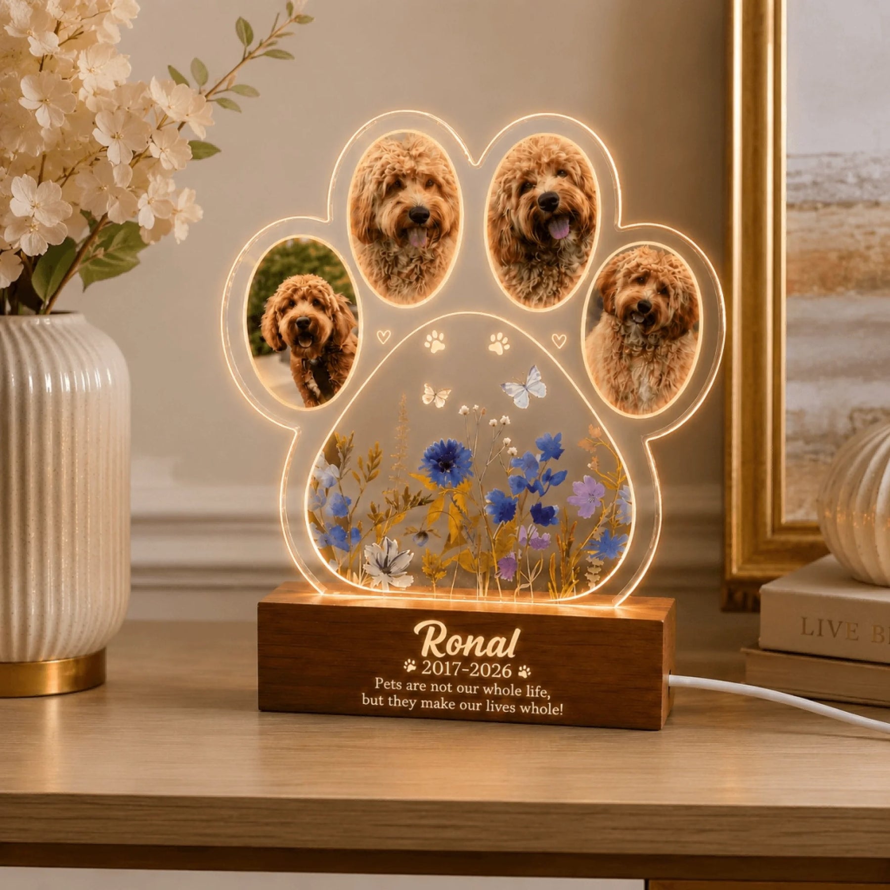 Custom pet memorial LED night light featuring a paw print shape with four photos of a dog, floral art, and a name.