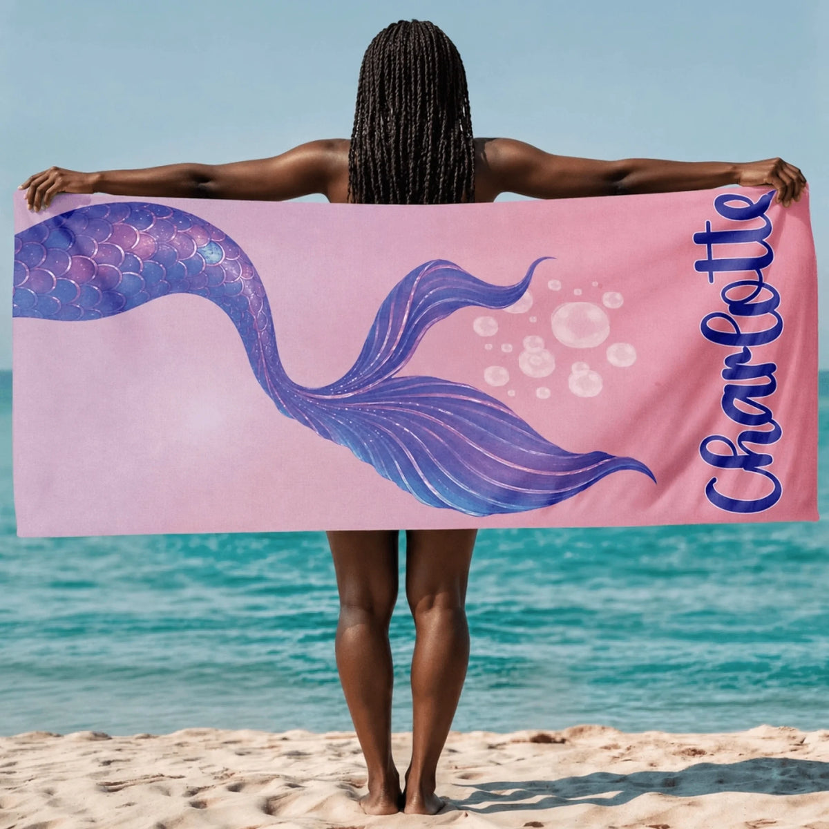 Custom Charlotte mermaid beach towel in a soft pink design with a shimmering tail for beach and swimming fun.