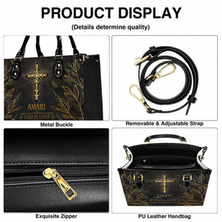A product detail view of a black personalized handbag showing the metal buckle adjustable strap sturdy zipper and spacious interior.